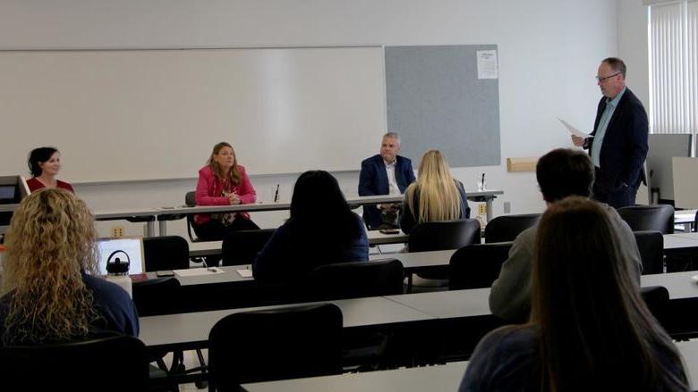 Members of the entrepreneur panel at Penn State DuBois receive an introduction from Brad Lashinsky, far left. Panel members seated at the table in front, from left to right, Michael Clement, Paula Foradora and Jennifer Reynolds-Hamilton.